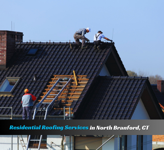 Residential roofing services in North Branford, CT – roofers installing new roof on a home.